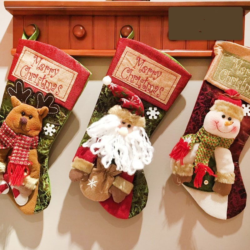 Festive Christmas stockings featuring a reindeer, Santa Claus, and a snowman with Merry Christmas messages
