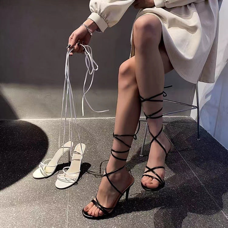 Stylish round toe stiletto heels in black with strappy design and elegant finish