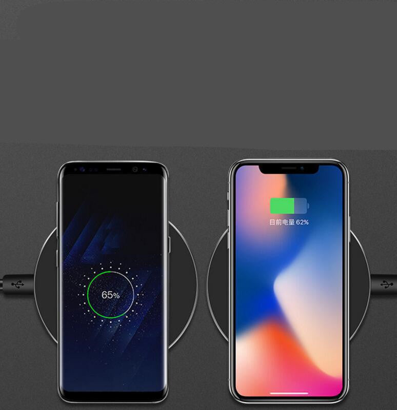 Two smartphones charging on a wireless fast charge pad with battery status indicator
