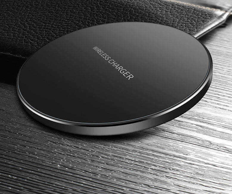 Sleek wireless fast charge pad on a wooden surface, designed for convenient charging of devices