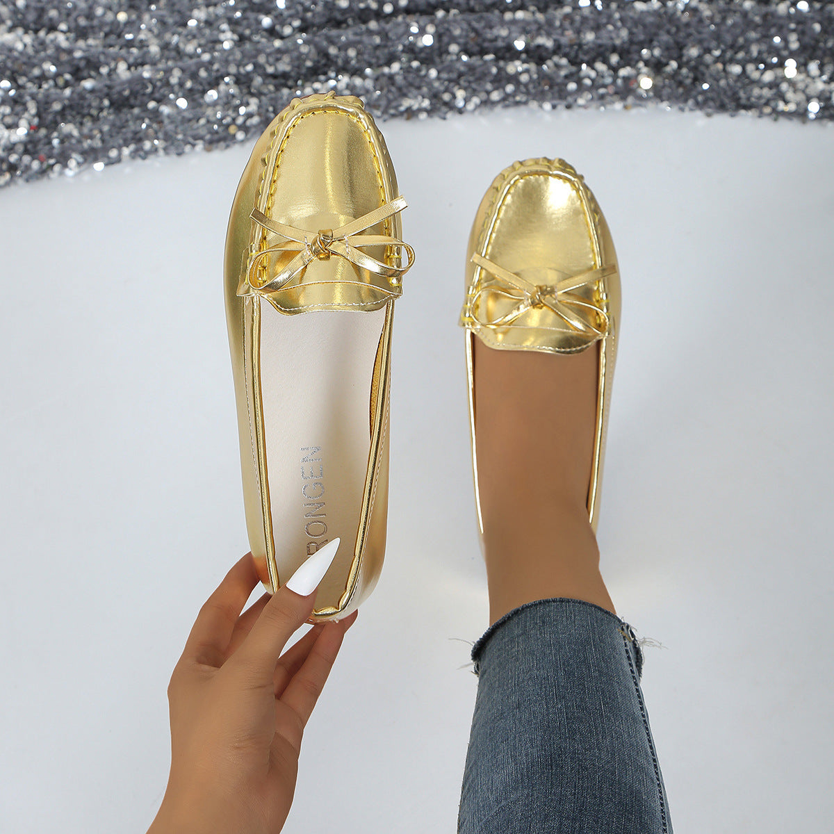 Shiny gold comfortable loafers for women with bow detail perfect for casual outings